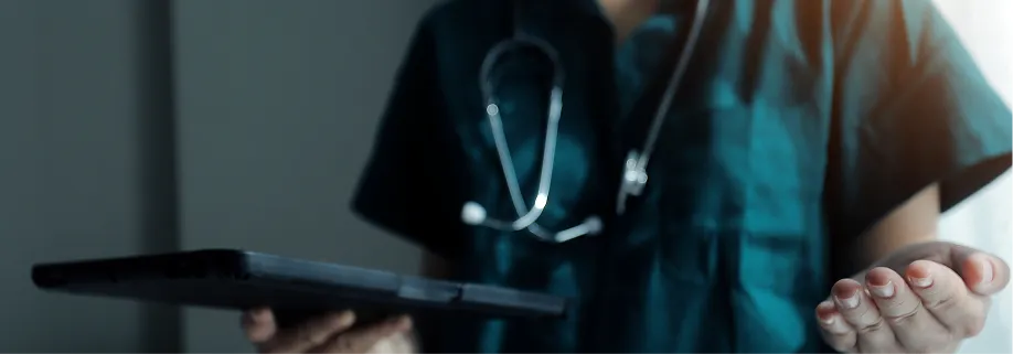 Medico con estetoscopio consultando una tablet